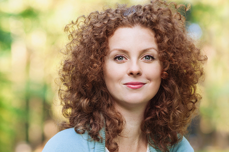 red haired woman looking at the camera